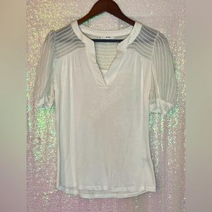 White top with sheer puff sleeve and shoulders.